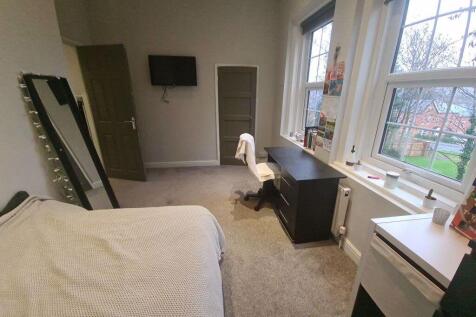 A bright and welcoming bedroom featuring a doub...