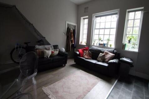 A well-lit, modern living room featuring two bl...