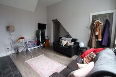 A spacious and well-lit living room with modern...