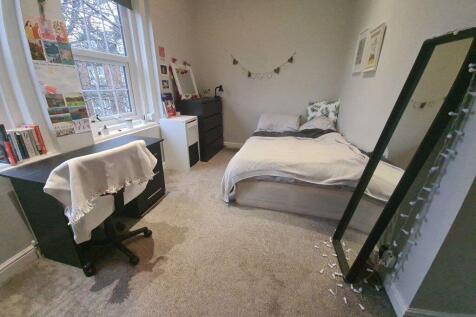 A cozy and inviting bedroom with natural light ...