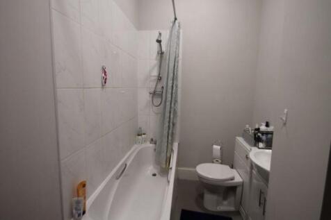 A clean and well-maintained bathroom with a bat...