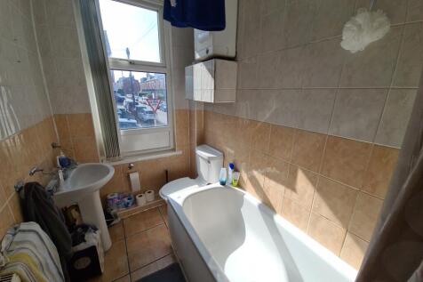 A bright and clean bathroom with a spacious bat...