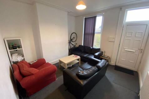 A bright and welcoming living room featuring a ...