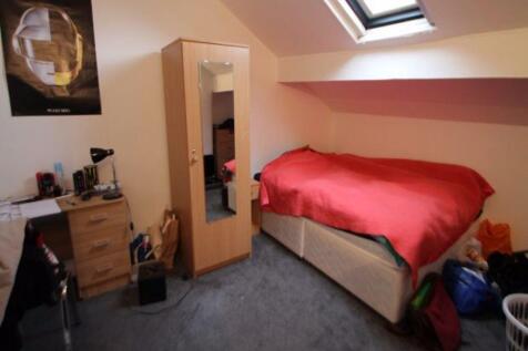 A bright and cozy master bedroom featuring a la...