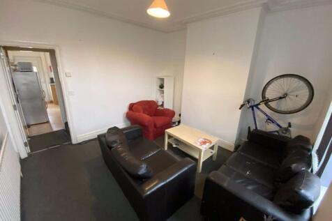 A contemporary living room featuring two sofas,...