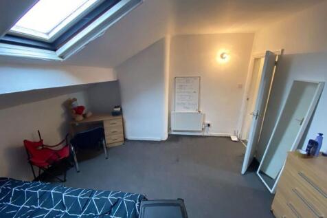 A bright, well-maintained bedroom with a window...