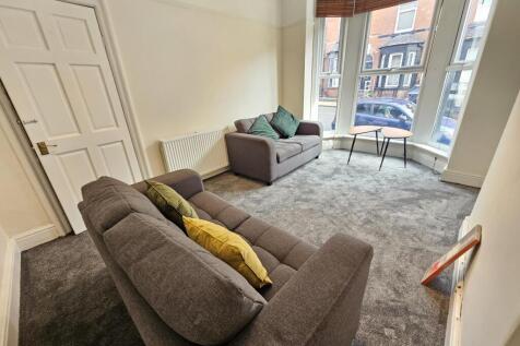 A bright and welcoming living room with comfort...