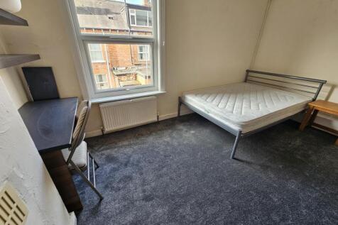 A compact and bright student room with a single...