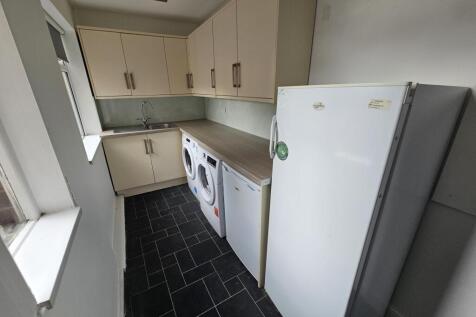 A bright and practical kitchen space featuring ...