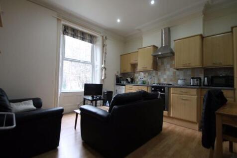 A bright and tidy kitchen-living area featuring...