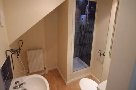 A clean and functional bathroom featuring a sho...