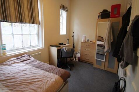 Cozy single bedroom featuring a comfortable bed...