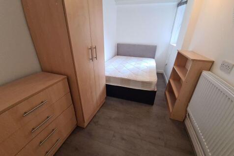 A neat and functional student bedroom featuring...