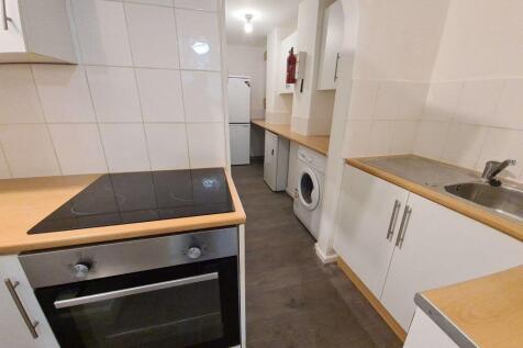 A bright and functional kitchen features modern...