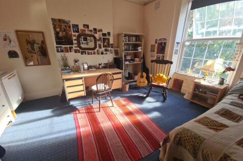 Bright and cozy living room featuring large win...