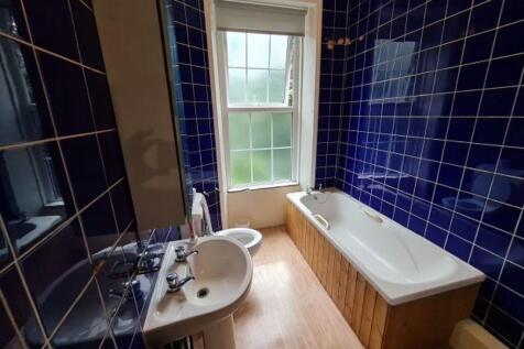 A clean and spacious bathroom featuring a large...