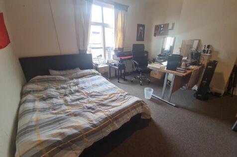 Bright and spacious bedroom featuring a large d...