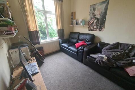 Cozy living room with comfortable black leather...
