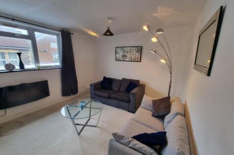A bright and welcoming living room featuring tw...