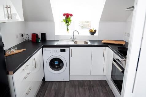 A modern and bright kitchen with ample natural ...