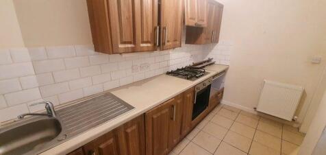 A modern kitchen with wooden cabinets, a built-...