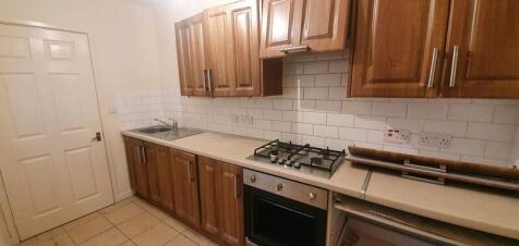 A well-maintained kitchen with wooden cabinetry...