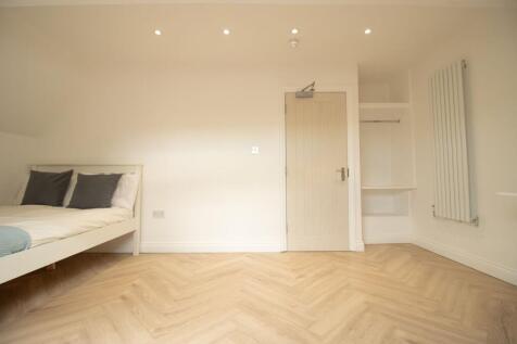 Bright and spacious bedroom featuring a comfort...