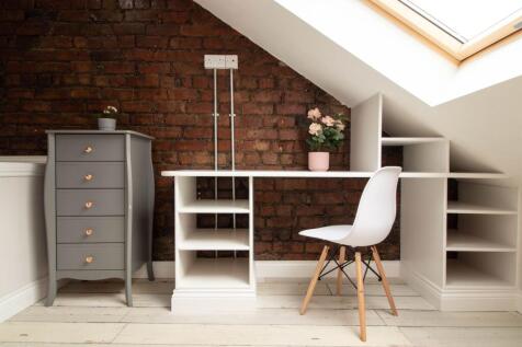 A well-lit, stylish study area featuring a whit...
