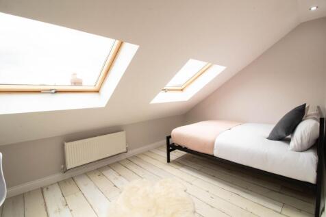 Bright and airy bedroom with two large skylight...