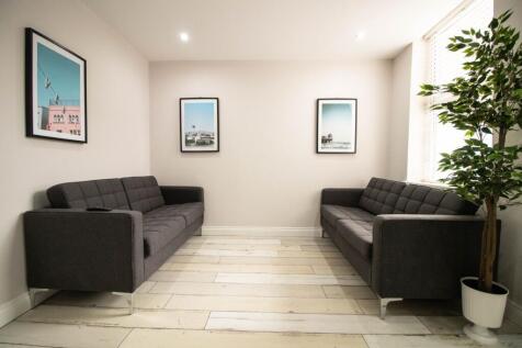 A modern and tidy living room featuring two dar...