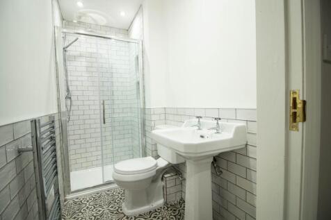Bright and clean bathroom with a classic white ...