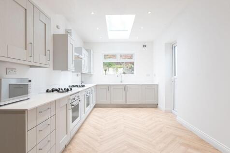Bright and modern kitchen featuring ample natur...