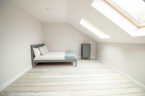 Bright and spacious master bedroom with large s...