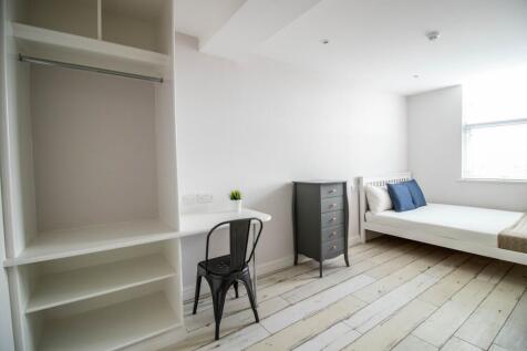 Bright and airy master bedroom featuring a comf...