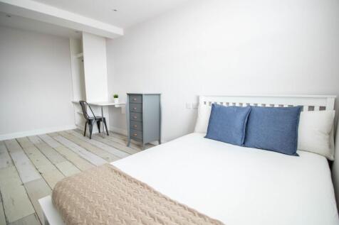 A bright and well-maintained bedroom with a sim...