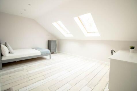 Bright and airy spacious master bedroom with la...