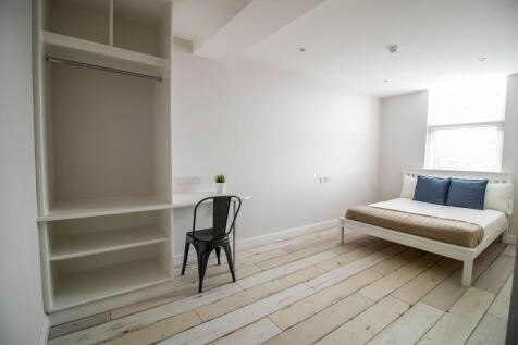 Bright and airy bedroom featuring a comfortable...