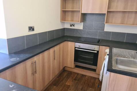 Modern kitchen with wood finish cabinets, integ...