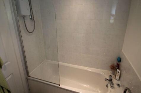 A clean and modern bathroom featuring a white b...