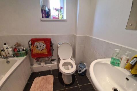 A clean and practical bathroom featuring a whit...