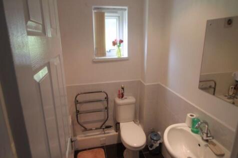 A clean and functional small toilet with a whit...