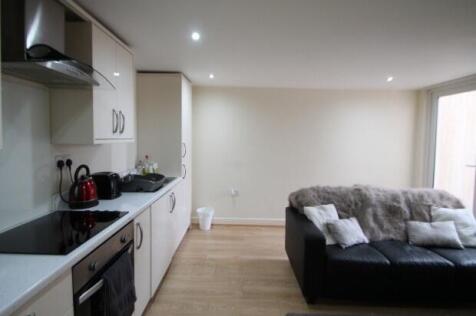 A modern, well-lit living room with large windo...