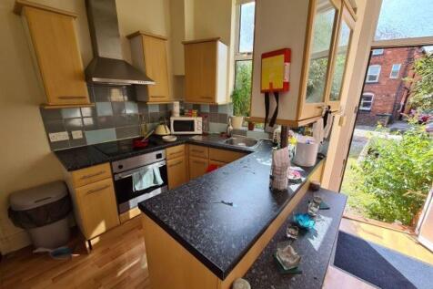 A bright and modern kitchen with ample natural ...
