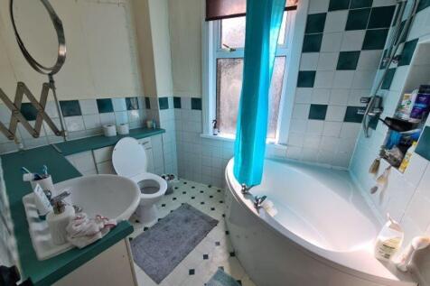 Bright and well-maintained bathroom with a larg...