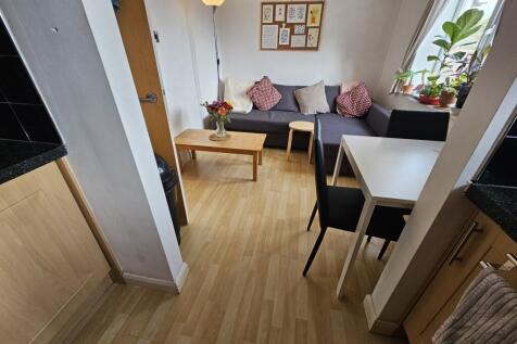 A cozy, well-maintained living room featuring c...