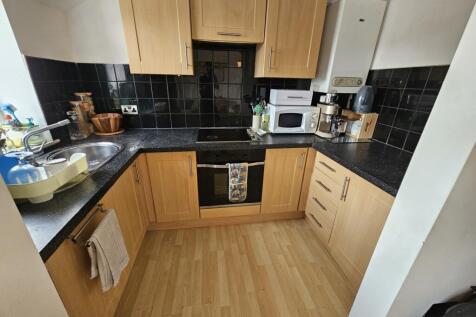 A bright and well-maintained kitchen with ample...