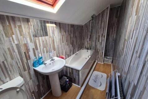 A clean and brightly lit bathroom featuring a b...