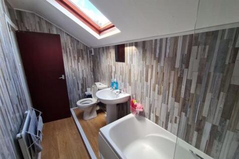 A well-maintained bathroom featuring a bathtub,...