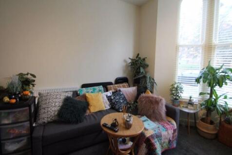 A bright and inviting living room featuring lar...