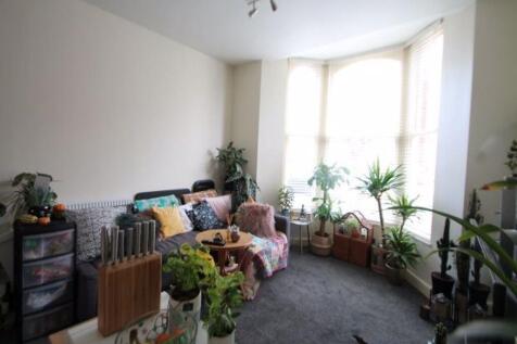 A bright and welcoming living room filled with ...